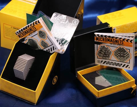 Micro 1728 and Micro 432 sets in their boxes, with construction guides and field viewing cards
